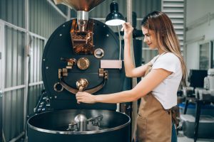 Small Business Coffee Factory, Professional Caucasian Female Entrepreneur Roasting Coffee in Factory
