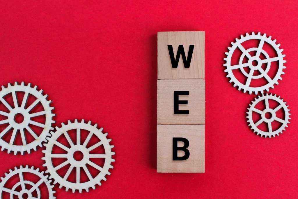Gear teeth forming a circle with the word 'web' embedded within, representing the intricacy of custom web design solutions.